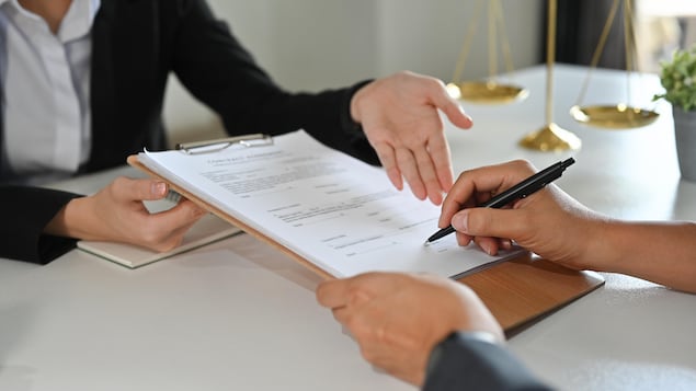 Cropped view of client signing contract or legal papers with lawyer. Law services concept.