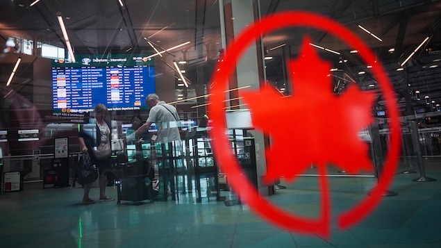 Des passagers s'enregistrent pour un vol.
