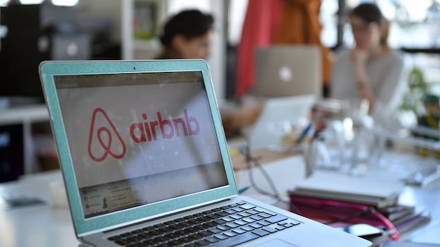Sur un ordinateur portable, une fenêtre pour réserver un logement sur Airbnb est ouverte.