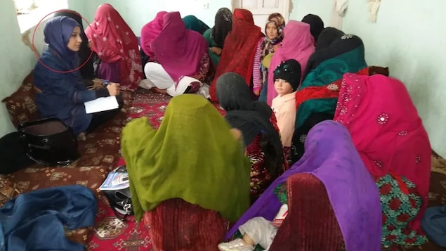 The work that Nelofar Akbari (circled left) did to teach Afghan village women about their legal rights put her on the wrong side of the Taliban.