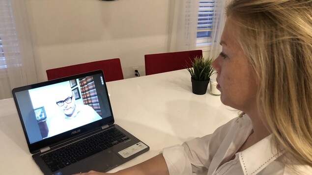 La candidate libérale Alison Gohel en rencontre virtuelle avec son chef Steven Del Duca. Elle prend par à un appel Zoom avec lui de sa table de cuisine.