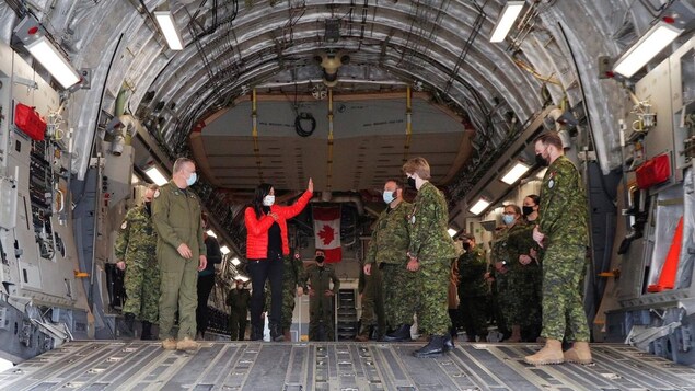 Defence Minister Anita Anand speaks with Canadian military personnel onboard a transport plane during a visit to highlight military aid for Ukraine at Canadian Forces Base Trenton in Trenton, Ont., April 14, 2022.