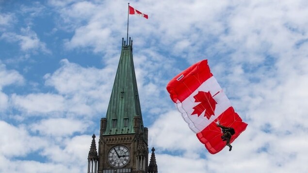 A skydiver glides beside the Peace tower during Canada Day events in Ottawa in 2022. Private members' bills may have their best effects when they're ambitious. (Lars Hagberg/The Canadian Press/The Associated Press)