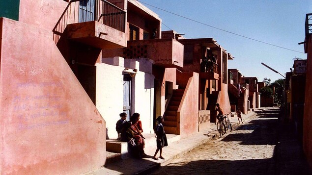 Des enfants jouent dans la rue à Indore, en Inde, devant des maisons à un étage de couleur ocre. Des enfants jouent dans la rue à Indore, en Inde, devant des maisons à un étage de couleur ocre.