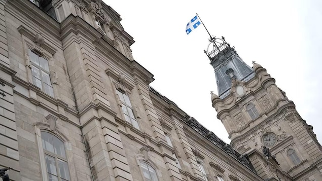 Quebec flag flies atop a building.