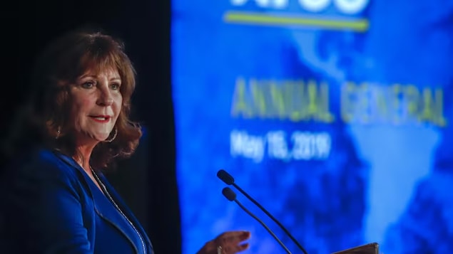 A woman speaks at a podium. 