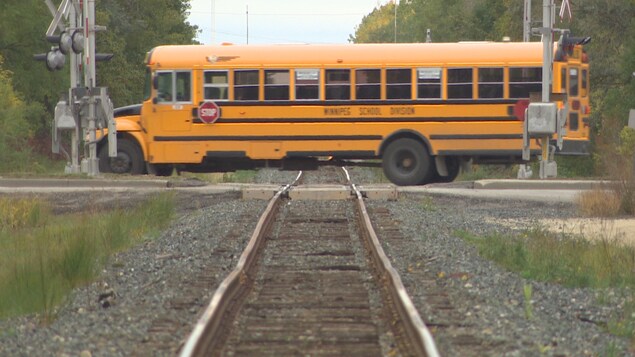 Un autobus scolaire traverse un passage à niveau à Winnipeg. Un autobus scolaire traverse un passage à niveau à Winnipeg.