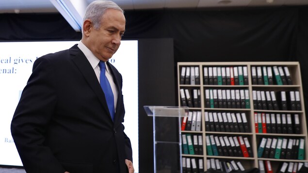 Nétanyahou quitte une scène sur laquelle on voit un écran utilisé pour présenter des informations obtenues par Israël et une bibliothèque contenant des dizaines de cartables.