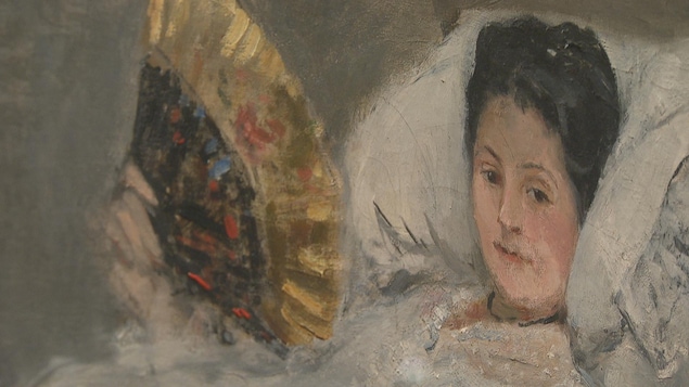 Une femme aux cheveux noirs est couchée dans un lit. Elle est vêtue de blanc et agite un éventail doré et noir. Une femme aux cheveux noirs est couchée dans un lit. Elle est vêtue de blanc et agite un éventail doré et noir.