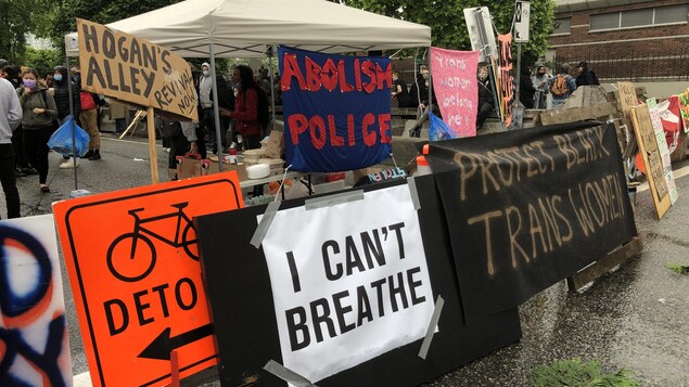 Des manifestants bloquent l'accès au viaduc Georgia avec des affiches aux messages solidaires du mouvement Black Lives Matter. 