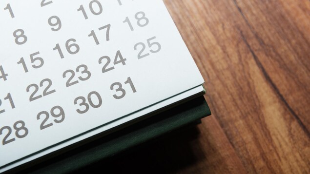 Un calendrier posé sur une table en bois.
