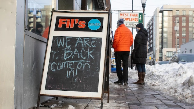 A sign outside a diner in Ottawa on Feb. 1, 2022, when indoor dining restrictions were lifted. While service sectors continue to be hit hard by the pandemic, other sectors have experienced strong growth.