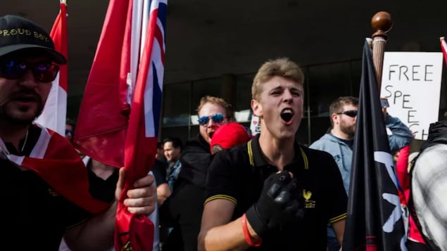 Members of the Proud Boys shout at a group of counter-protesters at Nathan Philips Square in Toronto on Saturday, October 21, 2017.