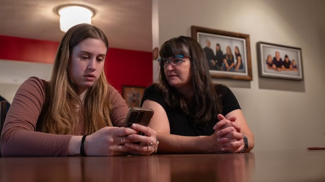 Emma Parsons scrolls through old messages on her phone that she received from an ex with her mother, Carmen. After the Ottawa nursing student blocked her ex on all platforms, she says he started contacting her by sending abusive messages attached to banking e-transfers. 