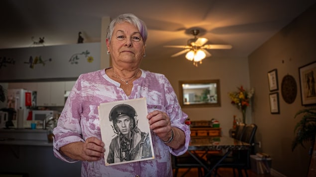 Marguerite Picard holds a picture of her brother Paul, who was killed in a plane crash while serving with the UN peacekeeping mission in the Sinai Peninsula in 1966 and is buried in the Gaza War Cemetery. 