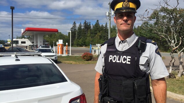 L'agent de la Gendarmerie royale du Canada Daniel LeBlanc pose avec sa voiture de police. L'agent de la Gendarmerie royale du Canada Daniel LeBlanc pose avec sa voiture de police.