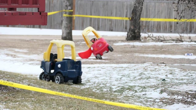Children's toys could be seen Monday in a yard in Carman, surrounded by yellow police tape.