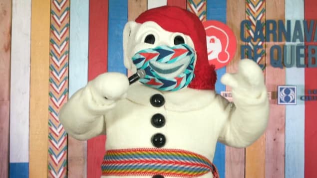Le Bonhomme Carnaval sur une scène, il porte un masque et parle avec un micro