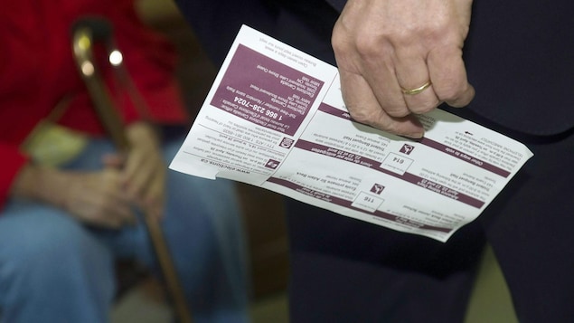A voter brings his voter information card to a federal polling booth.