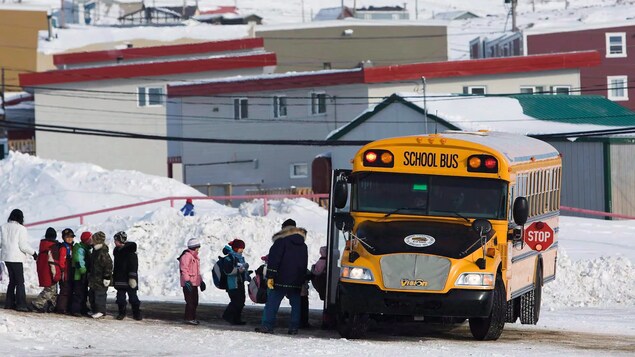 Students board a school bus at the Nakasuk Elementary School in Iqaluit.