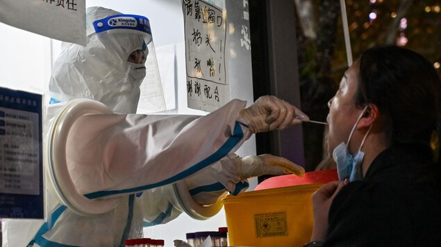 A health worker performs a test for COVID-19.