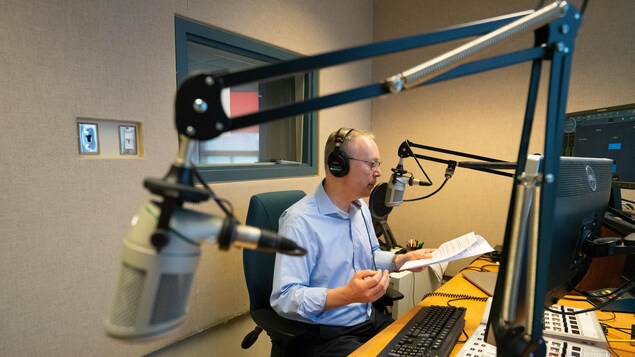 Christian Riou dans le studio de radio d'ICI Manitoba.