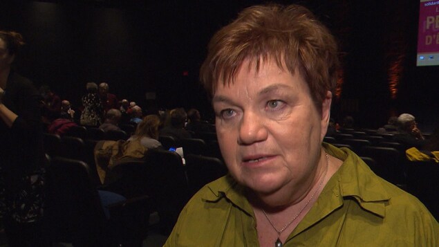 Claudette Carbonneau s'adresse à notre journaliste, à l'arrière d'un auditorium. Claudette Carbonneau s'adresse à notre journaliste, à l'arrière d'un auditorium.