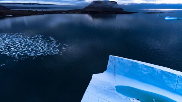 A melting pond is seen inside an iceberg from the Greenland ice sheet in the Baffin Bay near Pituffik, Greenland on July 20, 2022. A new policy brief recommends proactive measures be taken to prevent climate tipping points.