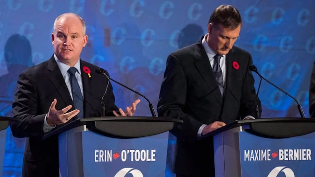 Conservative leadership candidate Erin O'Toole, left, speaks as Maxime Bernier listens during the Conservative leadership debate in Saskatoon, Wednesday, November 9, 2016. 