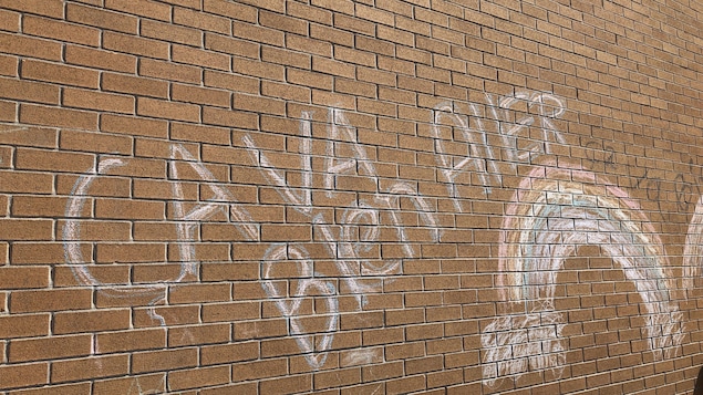 Un arc-en-ciel Ça va bien aller sur un mur d'école.