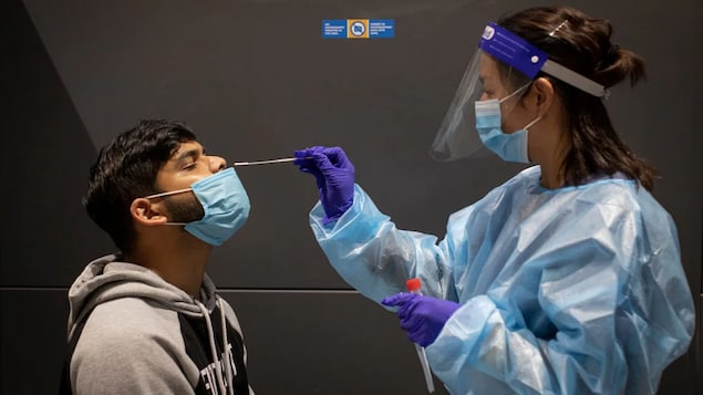 Passengers getting off international flights at Toronto's Pearson airport are shown getting mandatory COVID-19 tests on Feb. 1, 2021.