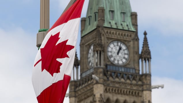 A Canadian flag hangs from a lamp post along the road in front of the Parliament buildings ahead of Canada Day in Ottawa,  Tuesday, June 30, 2020. Celebrations on Parliament Hill were cancelled this year due to the COVID-19 pandemic. THE CANADIAN PRESS/Adrian Wyld
