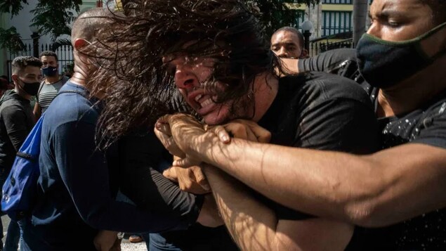 Plainclothes police detain an anti-government protester during a protest in Havana, Cuba, Sunday, July 11, 2021. A nationwide protest is planned for November 15 — the day the island nation reopens for tourism.