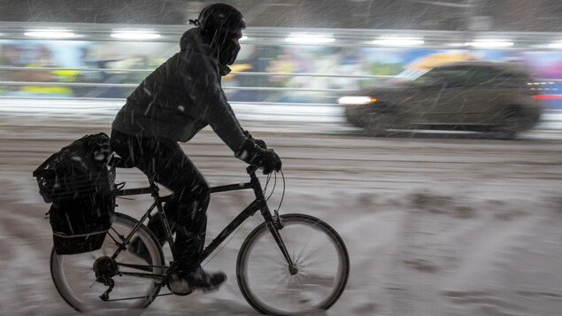 Un cycliste en hiver dans une rue de Toronto.