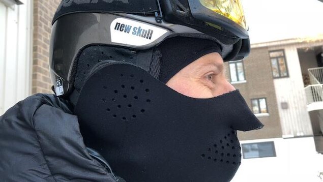 Un cycliste porte un casque, des lunettes et un cache-nez Un cycliste porte un casque, des lunettes et un cache-nez