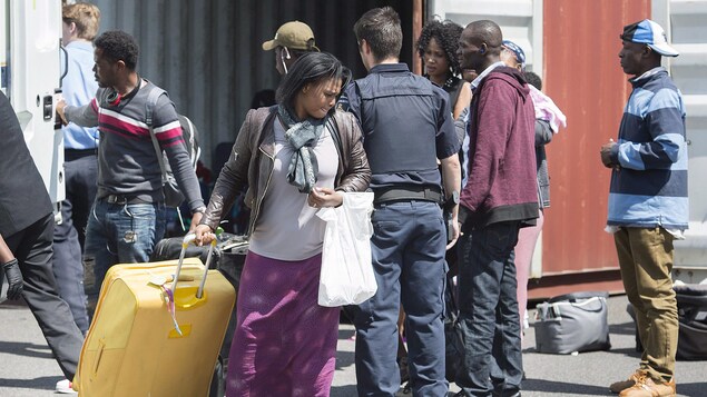 Sept demandeurs d'asile d'origine haïtienne arrivent à un centre de traitement des demandes à Saint-Bernard-de-Lacolle. Sept demandeurs d'asile d'origine haïtienne arrivent à un centre de traitement des demandes à Saint-Bernard-de-Lacolle.