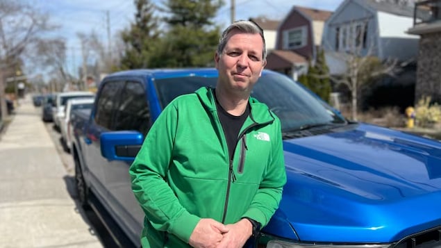 Derek Crocker stands in front of a replacement truck, after the one he bought at a Toronto dealership was identified as stolen. 