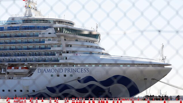Le navire de croisière Diamond Princess vu à travers une clôture en acier