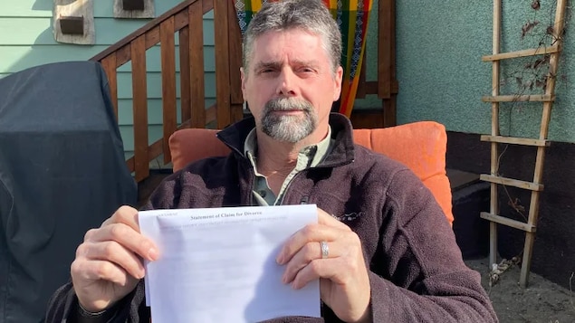 Aaron Penman holds one of the court documents a paralegal claimed had been filed with an Alberta court, only to discover the court had no record of it.