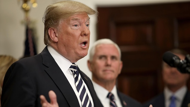 Donald Trump parle dans un micro. Près de lui, le vice-président, Mike Pence.