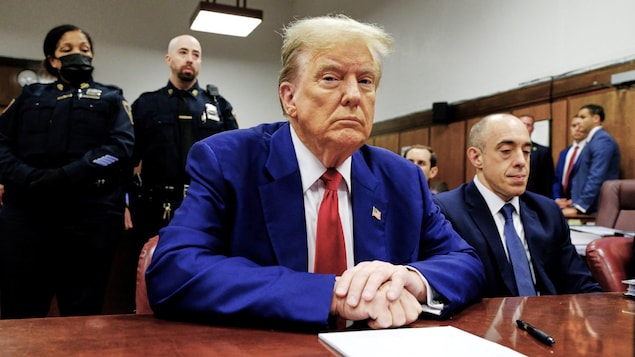 Former U.S. president Donald Trump awaits the start of proceedings at Manhattan criminal court on Tuesday in New York. The judge in his hush money trial found him in contempt of court, fining him and threatening him with jail time if he continues to violate a gag order.