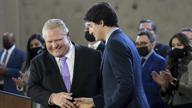 Prime Minister Justin Trudeau and Ontario Premier Doug Ford, shown here shaking hands in March after announcing a child-care deal, will be in Ingersoll, Ont., today to make an announcement about electric vehicles. 