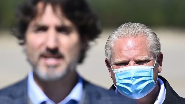 Prime Minister Justin Trudeau, front, speaks as Ontario Premier Doug Ford listens on Sept. 11, 2020. Ford's government has not yet signed a deal with Ottawa on child care, in part because of a 'money' disagreement, says a senior Ontario Progressive Conservative official.