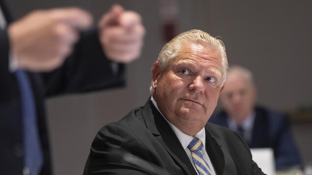 Le premier ministre Doug Ford écoute son homologue François Legault lors d'un sommet entre les deux provinces à Mississauga, en Ontario.