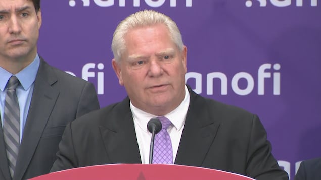 Ontario Premier Doug Ford (centre) delivers remarks while flanked by Prime Minister Justin Trudeau (left) , during a news conference in Toronto on May 30, 2024. 