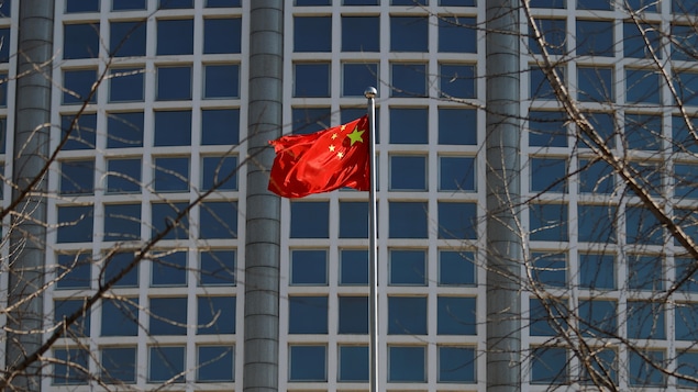 A chinese flag in front of a building