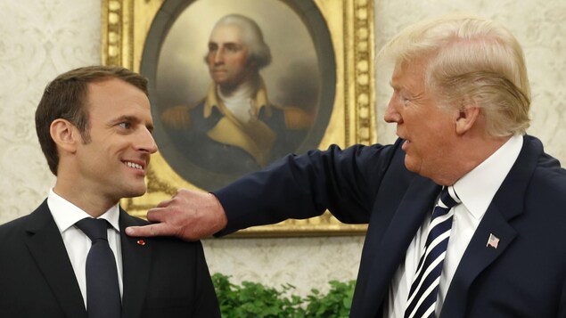 Donald Trump essuie du doigt l'épaule d'Emmanuel Macron. Donald Trump essuie du doigt l'épaule d'Emmanuel Macron.