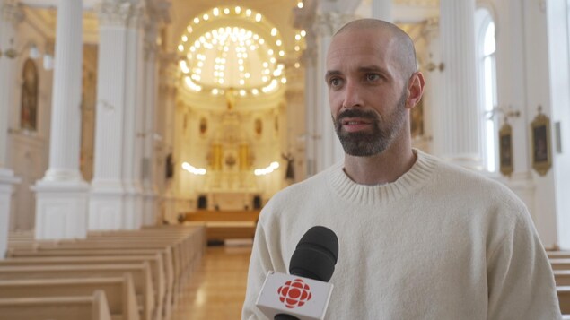 L'homme est en entrevue dans une église.