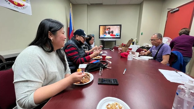 Isang grupo ng mga Pilipino sa loob ng isang kuwarto na nanonood sa TV ng resulta ng eleksyon sa Pilipinas.
