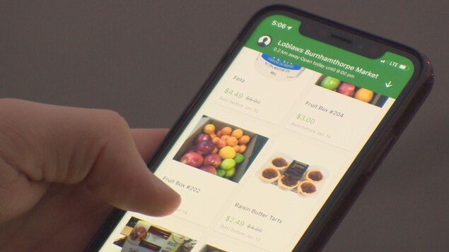 Une personne consulte l'application Flashfood sur son téléphone intelligent.